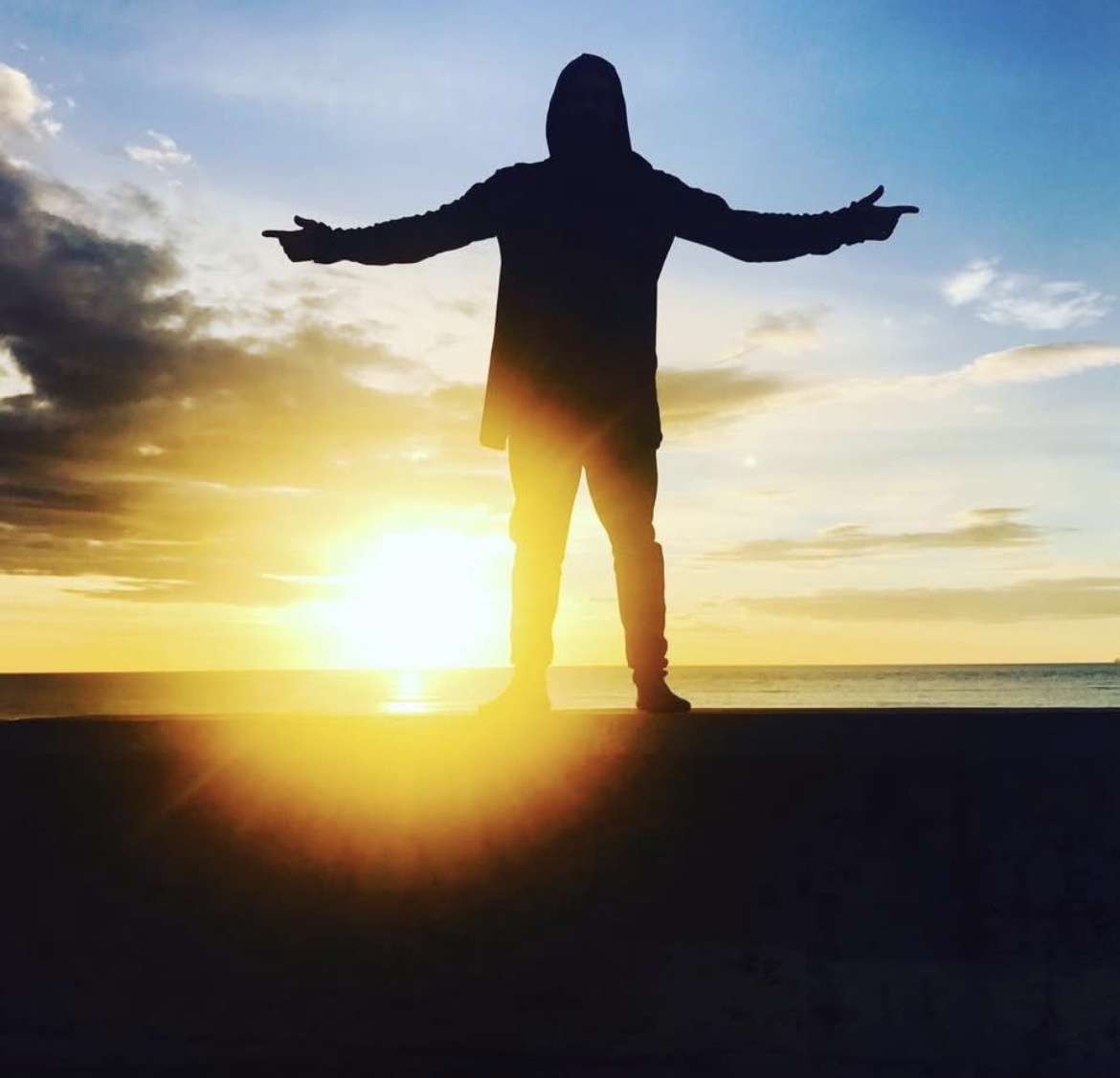 Bank Oliday silhouette at sunset by the sea